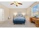 Well-lit bedroom features metal bed frame, window, and bedside tables at 25811 E Archer Ave, Aurora, CO 80018