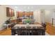 Dining area with wood table set adjacent to the kitchen with stainless appliances and wood flooring at 25811 E Archer Ave, Aurora, CO 80018