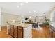 Open floor plan showcasing the kitchen island, dining area, living room, and staircase with wood flooring at 25811 E Archer Ave, Aurora, CO 80018