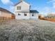 Backyard featuring a spacious lawn and a classic two-story home with a wooden fence providing privacy and charm at 25952 E 5Th Pl, Aurora, CO 80018