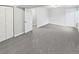 Finished basement with neutral carpeting, white walls, and multiple entry doors at 25952 E 5Th Pl, Aurora, CO 80018