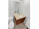 Bathroom with a large mirror, wood cabinets, and a white porcelain sink at 25952 E 5Th Pl, Aurora, CO 80018