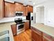 Kitchen features stainless steel appliances, wood cabinets, island and hardwood floors at 25952 E 5Th Pl, Aurora, CO 80018