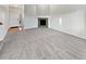 Spacious living room with neutral carpet, a fireplace, and a bright entryway showcasing a clean and modern design at 25952 E 5Th Pl, Aurora, CO 80018