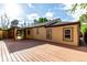 Exterior of home featuring backyard deck, covered patio, and neutral-toned paint at 1060 S Eaton St, Lakewood, CO 80226