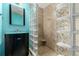Modern bathroom features a glass block shower, vanity with vessel sink, and blue accent wall at 1060 S Eaton St, Lakewood, CO 80226