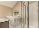 Bathroom with a tub featuring tile trim, shower, and window at 1060 S Eaton St, Lakewood, CO 80226