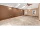 Spacious bedroom featuring a ceiling fan, dual skylights, and plush carpet at 1060 S Eaton St, Lakewood, CO 80226