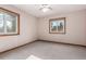 Bedroom featuring two windows, a ceiling fan, and carpet at 1060 S Eaton St, Lakewood, CO 80226