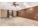 Bright bedroom featuring skylights, ceiling fan and sliding door access at 1060 S Eaton St, Lakewood, CO 80226