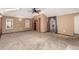 Large bedroom featuring carpet, closet, ceiling fan, and adjacent doorway to dining area at 1060 S Eaton St, Lakewood, CO 80226