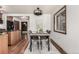 Charming dining area with wood floors, modern lighting, and bright window views at 1060 S Eaton St, Lakewood, CO 80226