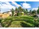 Spacious yard showcasing the home's exterior with mature trees, manicured landscaping and a classic fence at 1060 S Eaton St, Lakewood, CO 80226