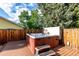 Backyard deck featuring a hot tub with surrounding privacy fence at 1060 S Eaton St, Lakewood, CO 80226