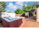Outdoor hot tub on wood deck with privacy screen, a serene space for relaxation and leisure in the backyard at 1060 S Eaton St, Lakewood, CO 80226