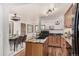 Open kitchen and dining area featuring dark countertops and wood flooring at 1060 S Eaton St, Lakewood, CO 80226