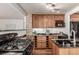 Cozy kitchen featuring granite countertops, wood cabinets and stainless steel appliances at 1060 S Eaton St, Lakewood, CO 80226