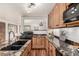 Stylish kitchen with granite countertops, wood cabinets, and modern lighting fixtures at 1060 S Eaton St, Lakewood, CO 80226