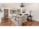 Inviting living room features hardwood floors, neutral paint, large windows and contemporary ceiling fan at 1060 S Eaton St, Lakewood, CO 80226
