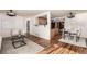 Open concept living space showcases hardwood floors, contemporary lighting and a pass-through to the kitchen at 1060 S Eaton St, Lakewood, CO 80226