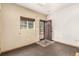 Room with neutral walls, carpet, and an exterior door with security screen at 1060 S Eaton St, Lakewood, CO 80226