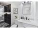Modern bathroom featuring black accents, sleek fixtures, and a glass shower at 5060 S Fox St, Englewood, CO 80110