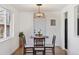 Charming dining room featuring a round table, wood chairs, and modern light fixture at 5060 S Fox St, Englewood, CO 80110