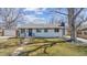 Charming home featuring a well-maintained lawn, landscaping, and inviting front porch at 5060 S Fox St, Englewood, CO 80110