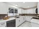 Modern kitchen boasting white cabinets, sleek countertops, and stainless steel appliances at 5060 S Fox St, Englewood, CO 80110