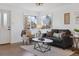 Cozy living room featuring neutral décor, plush seating, and inviting natural light at 5060 S Fox St, Englewood, CO 80110