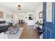Open-concept living room with hardwood floors, stylish furnishings, and an inviting atmosphere at 5060 S Fox St, Englewood, CO 80110