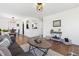 Open-concept living room featuring modern decor, hardwood floors, and smooth transition to dining area at 5060 S Fox St, Englewood, CO 80110