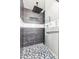 Luxurious black marbled shower with mosaic floors and glass door at 5060 S Fox St, Englewood, CO 80110