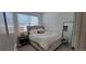 Bedroom with neutral carpet, large bed with a headboard, and bedside table at 9279 Merino Ct # B, Littleton, CO 80125