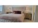 Beautiful bedroom with a tufted headboard, mirrored nightstands, and decorative throw pillows at 9279 Merino Ct # B, Littleton, CO 80125