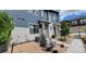 Well-maintained two-story home with blue and beige siding, landscaped front yard with seating area, and concrete walkway at 9279 Merino Ct # B, Littleton, CO 80125