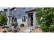 Charming two-story home featuring modern architectural design, stone accents, and a cozy front patio with seating at 9279 Merino Ct # B, Littleton, CO 80125