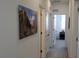Hallway with neutral carpet and white walls featuring an interesting framed piece of artwork at 9279 Merino Ct # B, Littleton, CO 80125