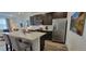 Modern kitchen featuring stainless steel appliances, dark cabinets, and a stylish breakfast bar, perfect for cooking and entertaining at 9279 Merino Ct # B, Littleton, CO 80125
