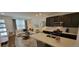 Open concept living space with modern kitchen, island seating, and a cozy living room, ideal for entertaining at 9279 Merino Ct # B, Littleton, CO 80125
