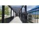 Covered walkway with a metal fence leading to a community building entrance, providing shaded access at 9279 Merino Ct # B, Littleton, CO 80125