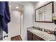 Bathroom featuring a walk-in shower, vanity and a large mirror at 384 S Ironton St # 201, Aurora, CO 80012