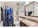 Cozy bathroom featuring a shower with glass door, granite counters, and updated fixtures at 384 S Ironton St # 201, Aurora, CO 80012