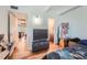 Bedroom with wood floors and a door to an ensuite bathroom at 384 S Ironton St # 201, Aurora, CO 80012