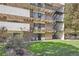Exterior view of apartments, featuring multiple balconies, stairwell, and well-maintained green spaces at 384 S Ironton St # 201, Aurora, CO 80012