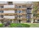 Exterior view of apartments, featuring multiple balconies, stairwell, and well-maintained green spaces at 384 S Ironton St # 201, Aurora, CO 80012