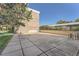 View of a community space with a concrete patio area, building and foliage at 384 S Ironton St # 201, Aurora, CO 80012