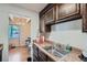 Galley kitchen with stainless steel sink, wooden cabinets and granite effect countertops at 384 S Ironton St # 201, Aurora, CO 80012