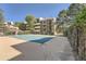 Community pool with building in the background and trees surrounding the area at 384 S Ironton St # 201, Aurora, CO 80012