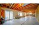 Spacious unfinished basement with slider door, exposed ceiling and framing, awaiting customization at 9832 N Crystal Lake Dr, Littleton, CO 80125